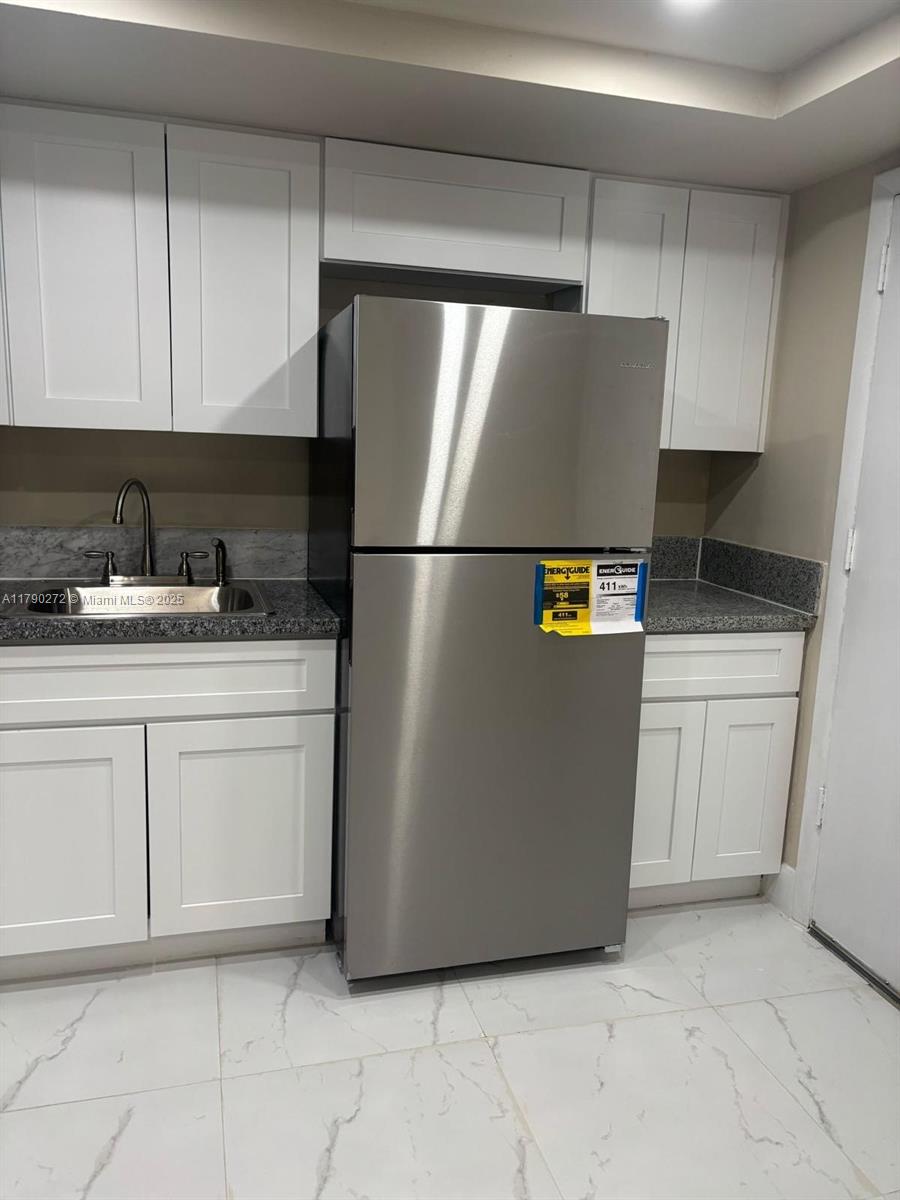 Ojus Miami, FL 33179 - Photo 3 of 15 a kitchen with cabinets and white refrigerator