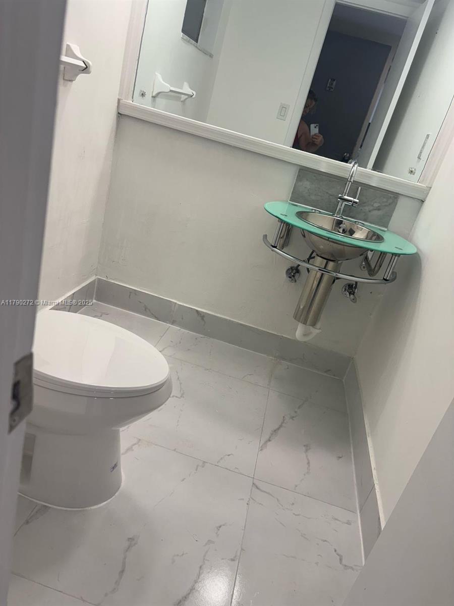 Ojus Miami, FL 33179 - Photo 6 of 15 a bathroom with a toilet and a sink