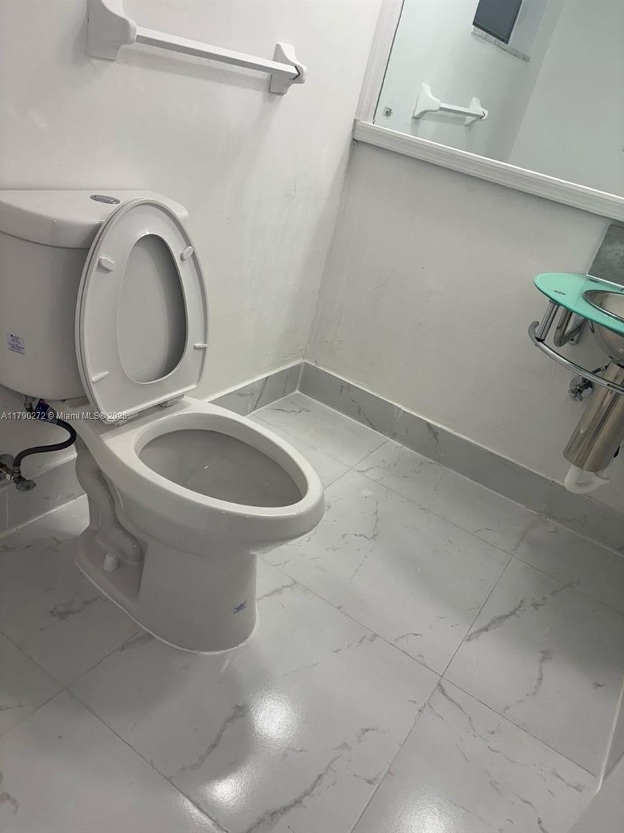Ojus Miami, FL 33179 - Photo 7 of 15 a bathroom with a toilet and a sink