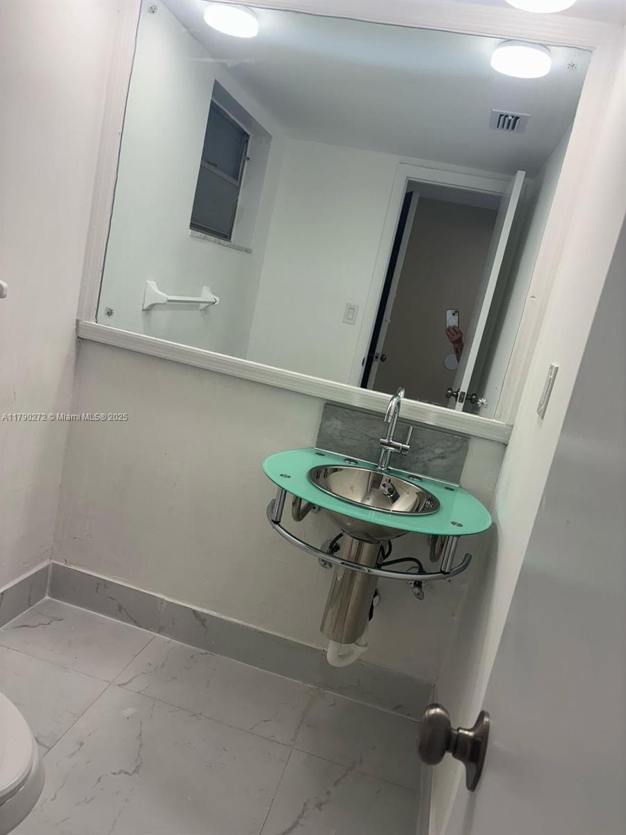 Ojus Miami, FL 33179 - Photo 8 of 15 a bathroom with a sink and mirror