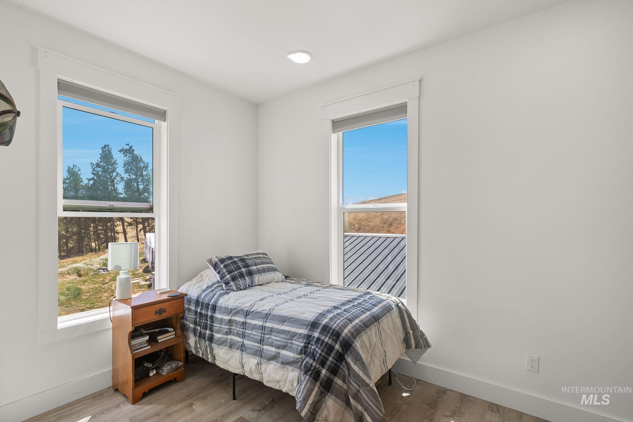 4935 Lenville Road Moscow, ID 83843 - Photo 30 of 49 Bright interior room featuring two large windows, recessed ceiling lighting, and wood-finish flooring
