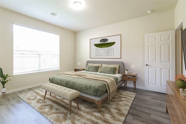 a bedroom with a bed and a window