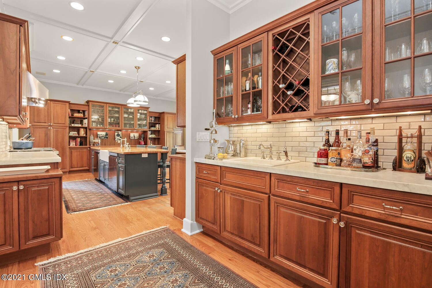 1 North Street Greenwich, CT 06830 - Photo 15 of 36 a open kitchen with stainless steel appliances granite countertop a refrigerator a sink dishwasher and a dining table with wooden floor