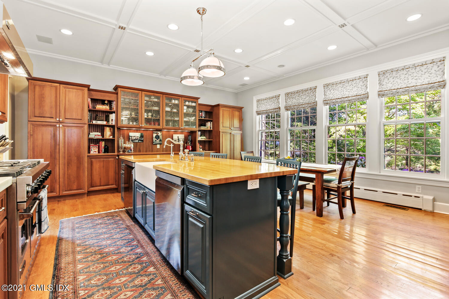 1 North Street Greenwich, CT 06830 - Photo 16 of 36 a kitchen with stainless steel appliances granite countertop a stove top oven a dining table and chairs