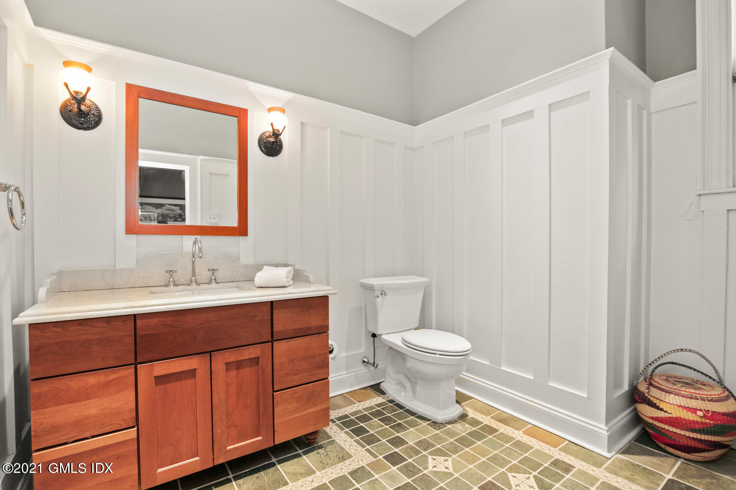 1 North Street Greenwich, CT 06830 - Photo 20 of 36 a bathroom with a sink a toilet and a mirror