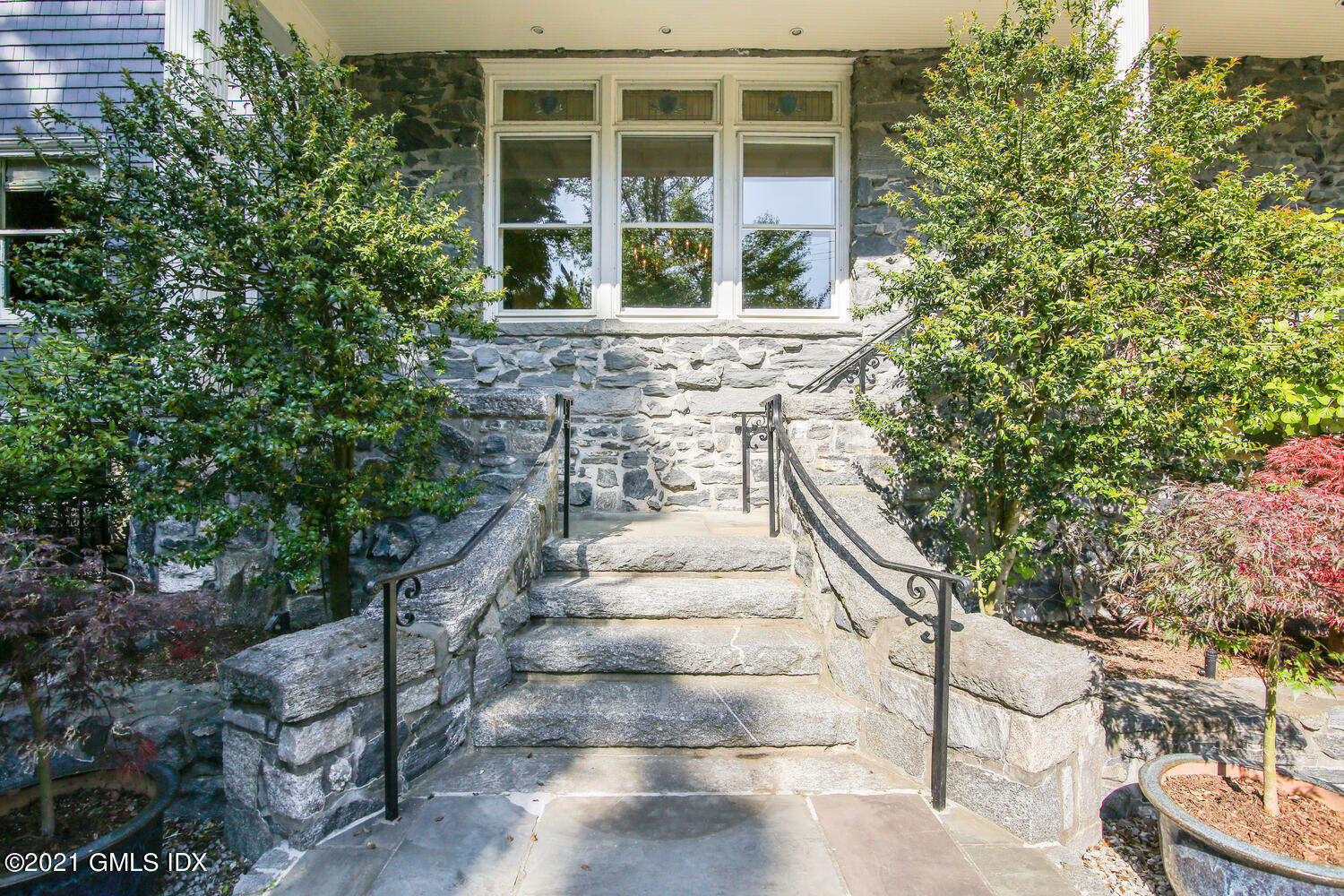 1 North Street Greenwich, CT 06830 - Photo 2 of 36 a front view of a house with a yard