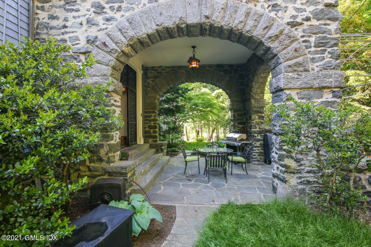 1 North Street Greenwich, CT 06830 - Photo 35 of 36 a view of a patio with table and chairs potted plants