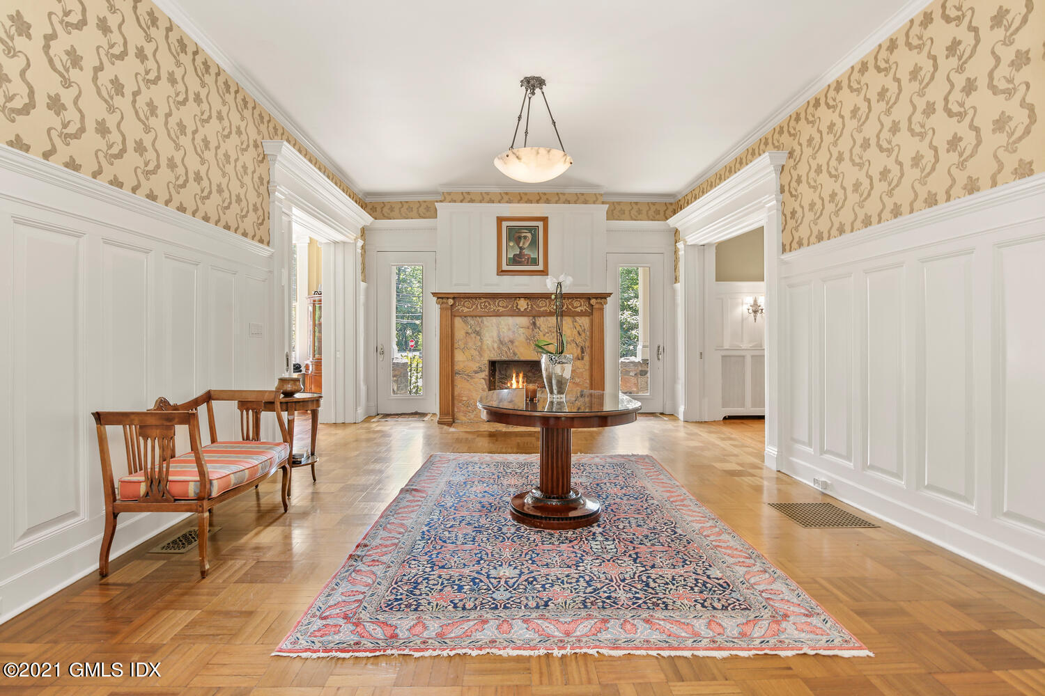 1 North Street Greenwich, CT 06830 - Photo 4 of 36 a view of a livingroom with furniture a fireplace and wooden floor