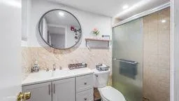 a bathroom with a toilet sink and mirror