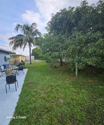 a view of a swimming pool with a table and chairs