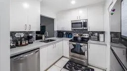 a kitchen with a sink stove and cabinets