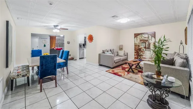 a living room with furniture and a dining table