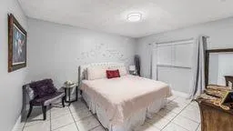 a bedroom with a bed and a chair