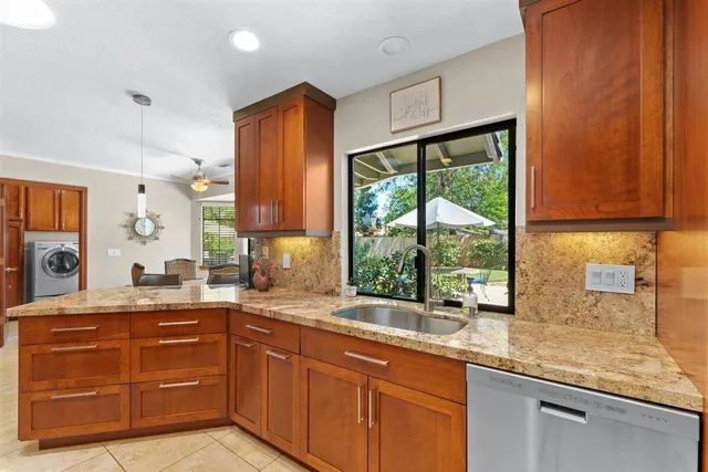 a spacious bathroom with a granite countertop sink and a large mirror