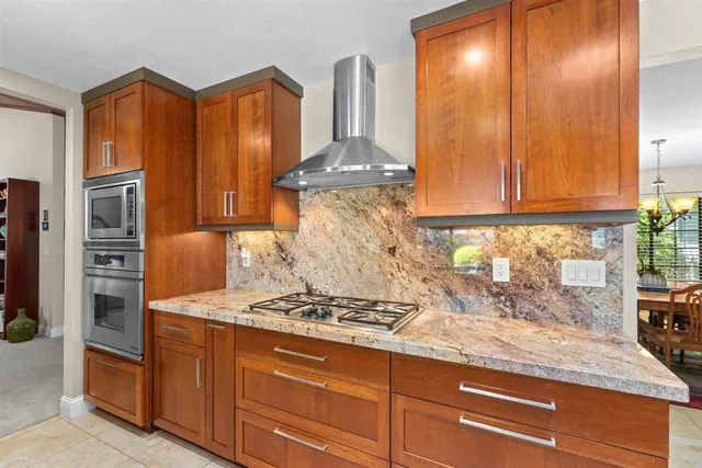 a kitchen with stainless steel appliances granite countertop a stove and a refrigerator