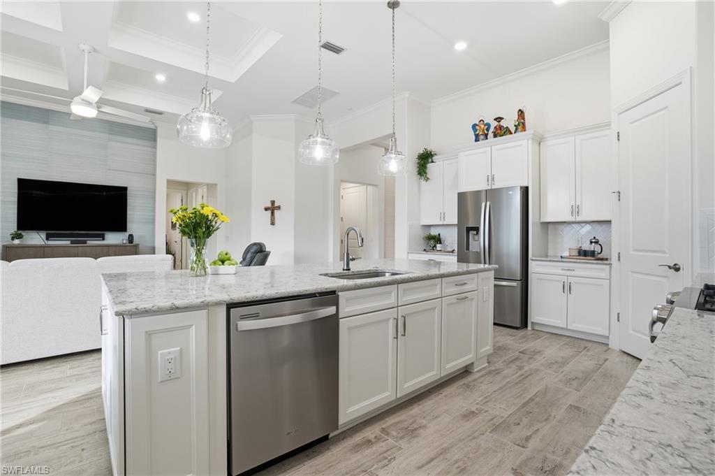 17210 Ashcomb Way Estero, FL 33928 - Photo 4 of 47 a kitchen with white cabinets and refrigerator