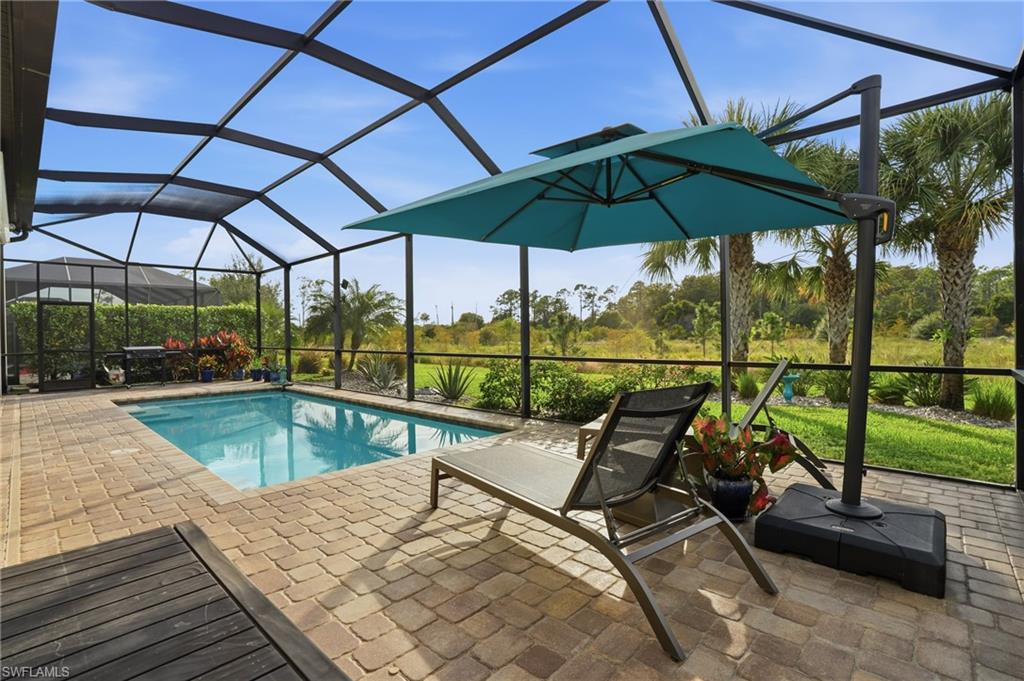 17210 Ashcomb Way Estero, FL 33928 - Photo 6 of 47 a view of a swimming pool with a patio