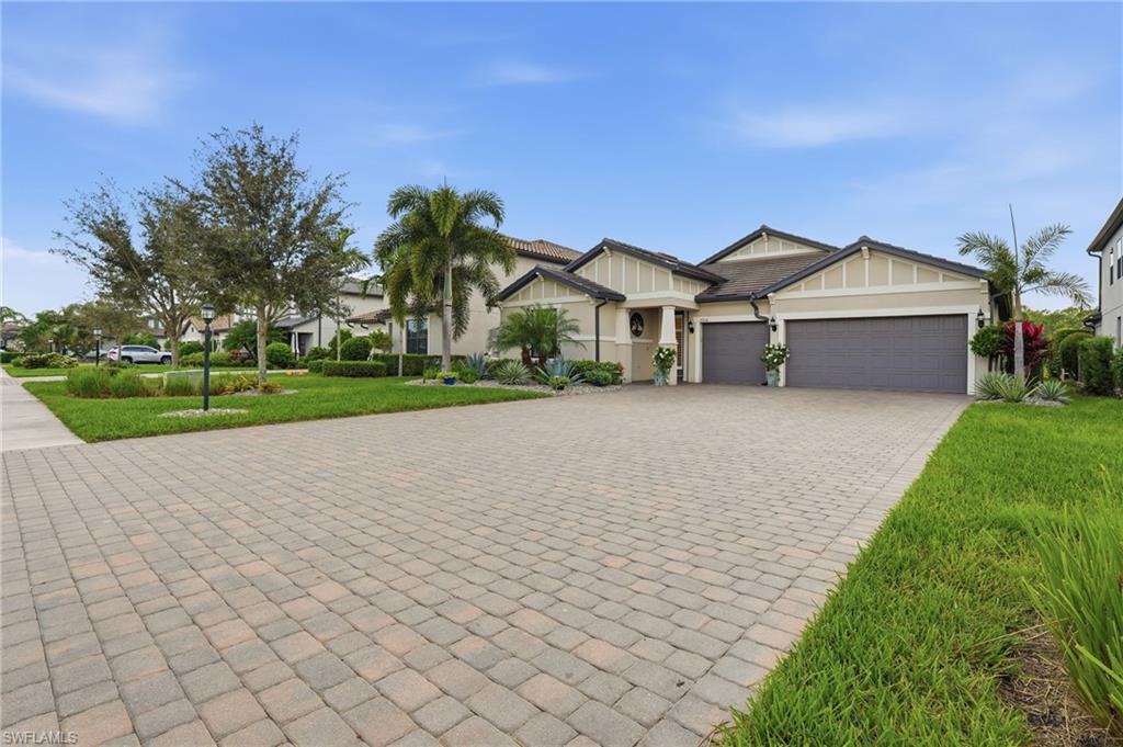 17210 Ashcomb Way Estero, FL 33928 - Photo 8 of 47 a front view of a house with a yard and garage
