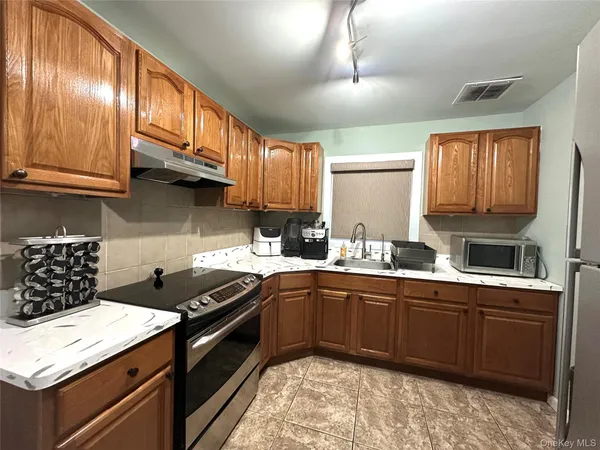 a kitchen with a sink a stove and cabinets