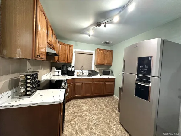 a kitchen with stainless steel appliances a refrigerator sink and cabinets