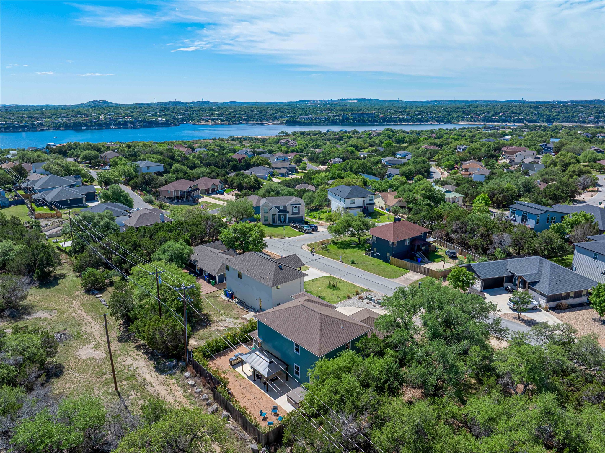 410 Summit Ridge Drive North Point Venture, TX 78645 - Photo 27 of 37 an aerial view of a city with lots of residential buildings and mountain view in back
