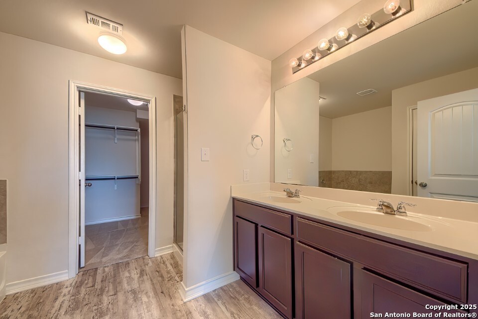 7006 Quantum Loop San Antonio, TX 78252 - Photo 15 of 37 a bathroom with a double vanity sink and mirror