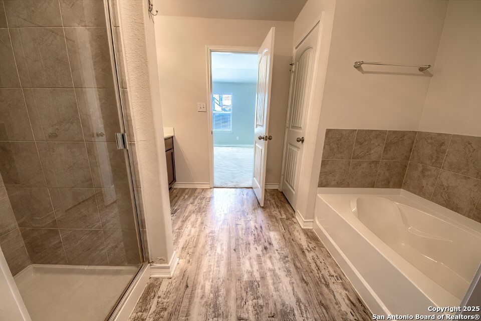7006 Quantum Loop San Antonio, TX 78252 - Photo 16 of 37 a bathroom with a bathtub and a shower