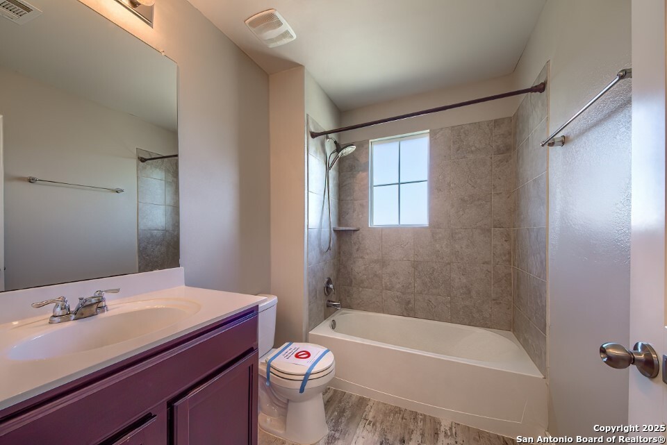 7006 Quantum Loop San Antonio, TX 78252 - Photo 22 of 37 a bathroom with a bathtub shower sink vanity mirror and toilet