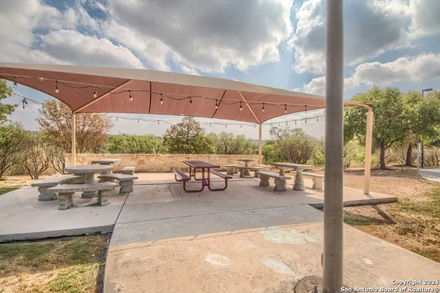 a patio with a table and chairs under an umbrella