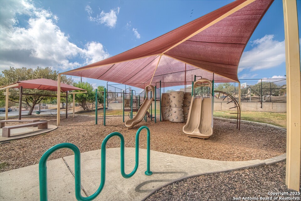 7006 Quantum Loop San Antonio, TX 78252 - Photo 33 of 37 a patio with a table and chairs under an umbrella