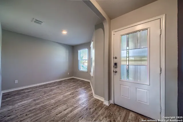wooden floor in an empty room with a window