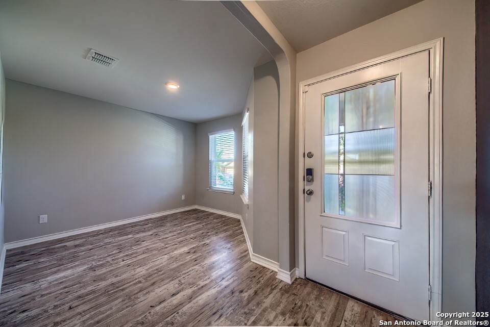 7006 Quantum Loop San Antonio, TX 78252 - Photo 5 of 37 wooden floor in an empty room with a window