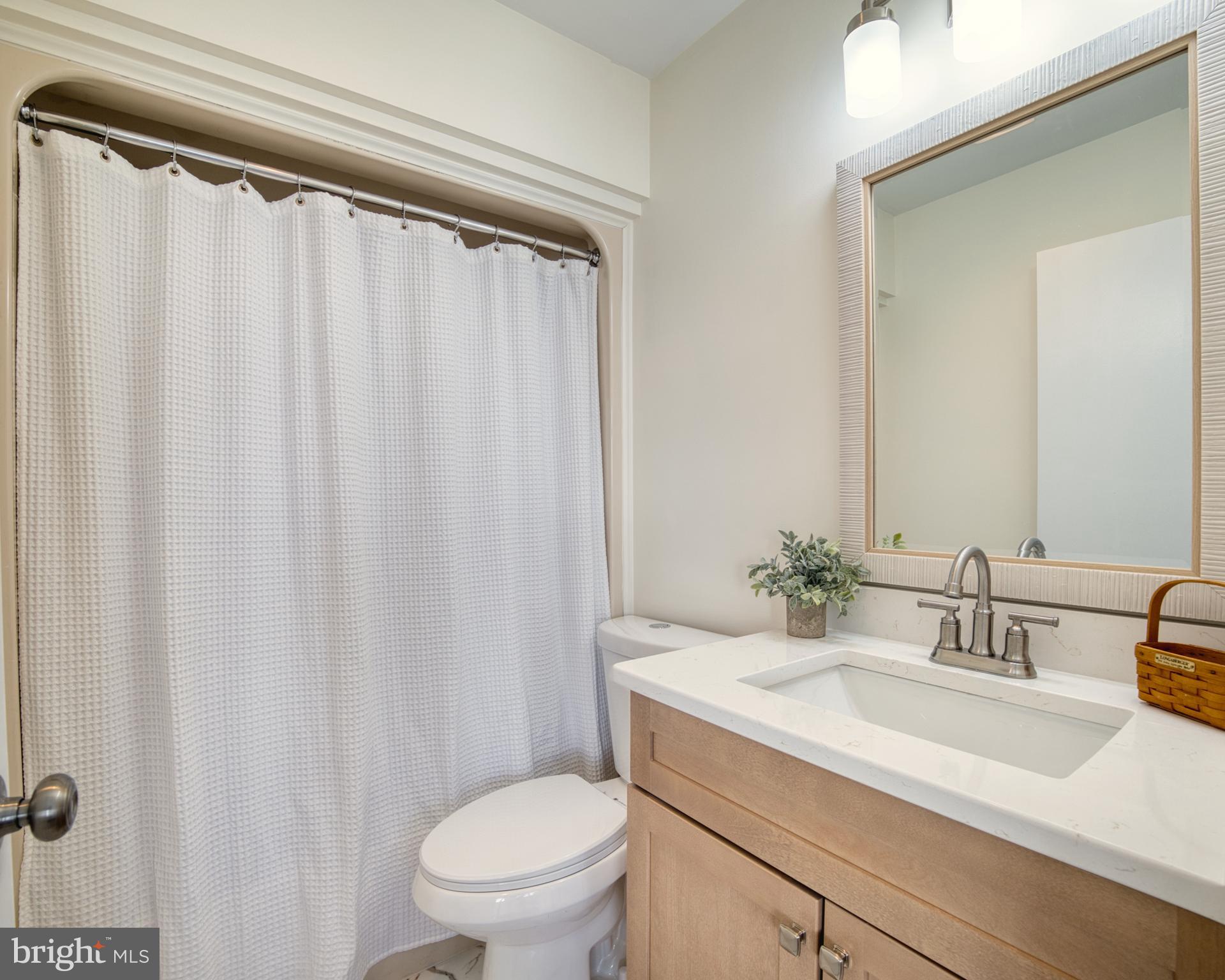 34 Queen Anne Way Chester, MD 21619 - Photo 17 of 52 a bathroom with a granite countertop sink and a mirror