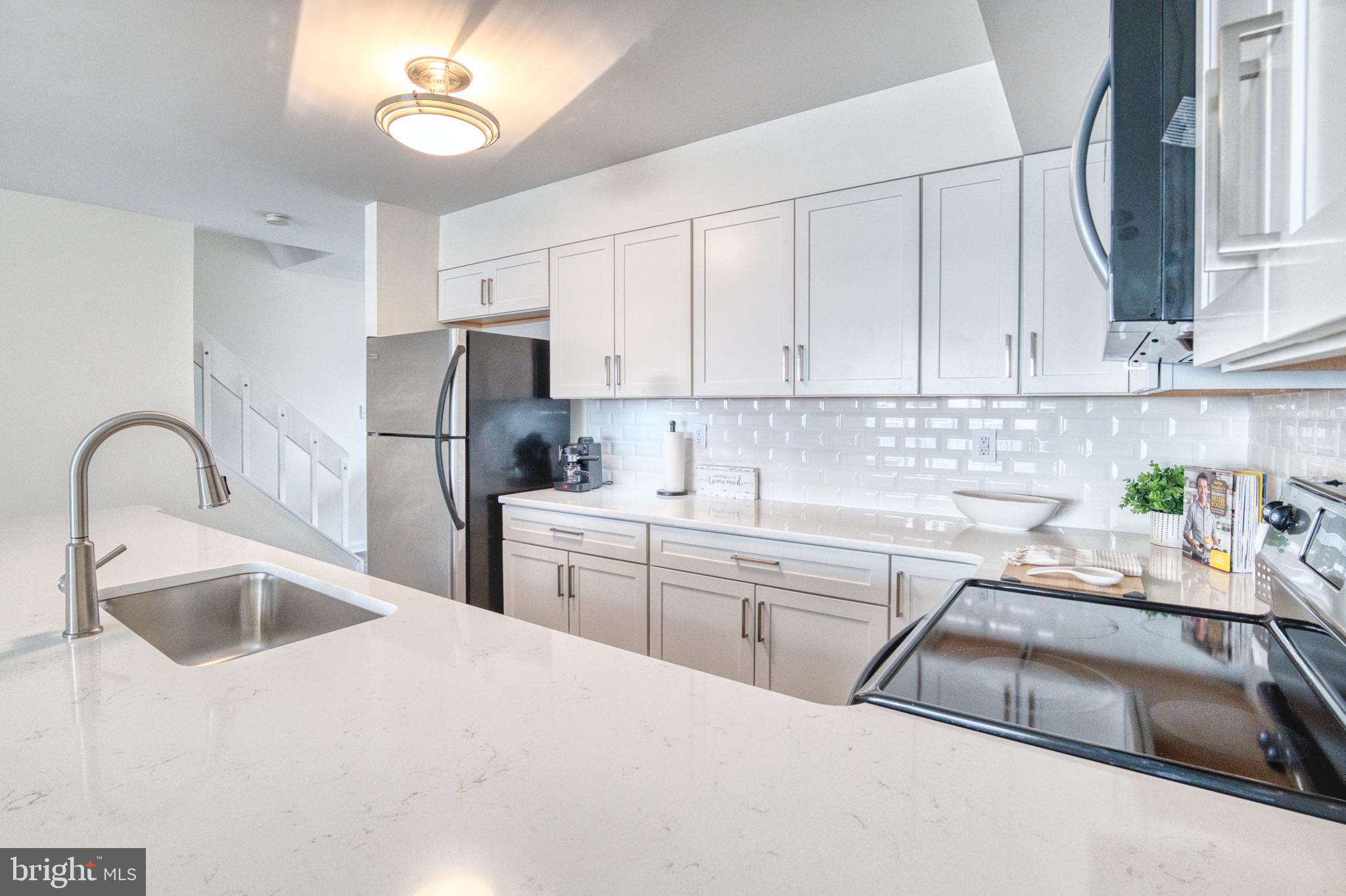 34 Queen Anne Way Chester, MD 21619 - Photo 3 of 52 a kitchen with a sink cabinets and stainless steel appliances