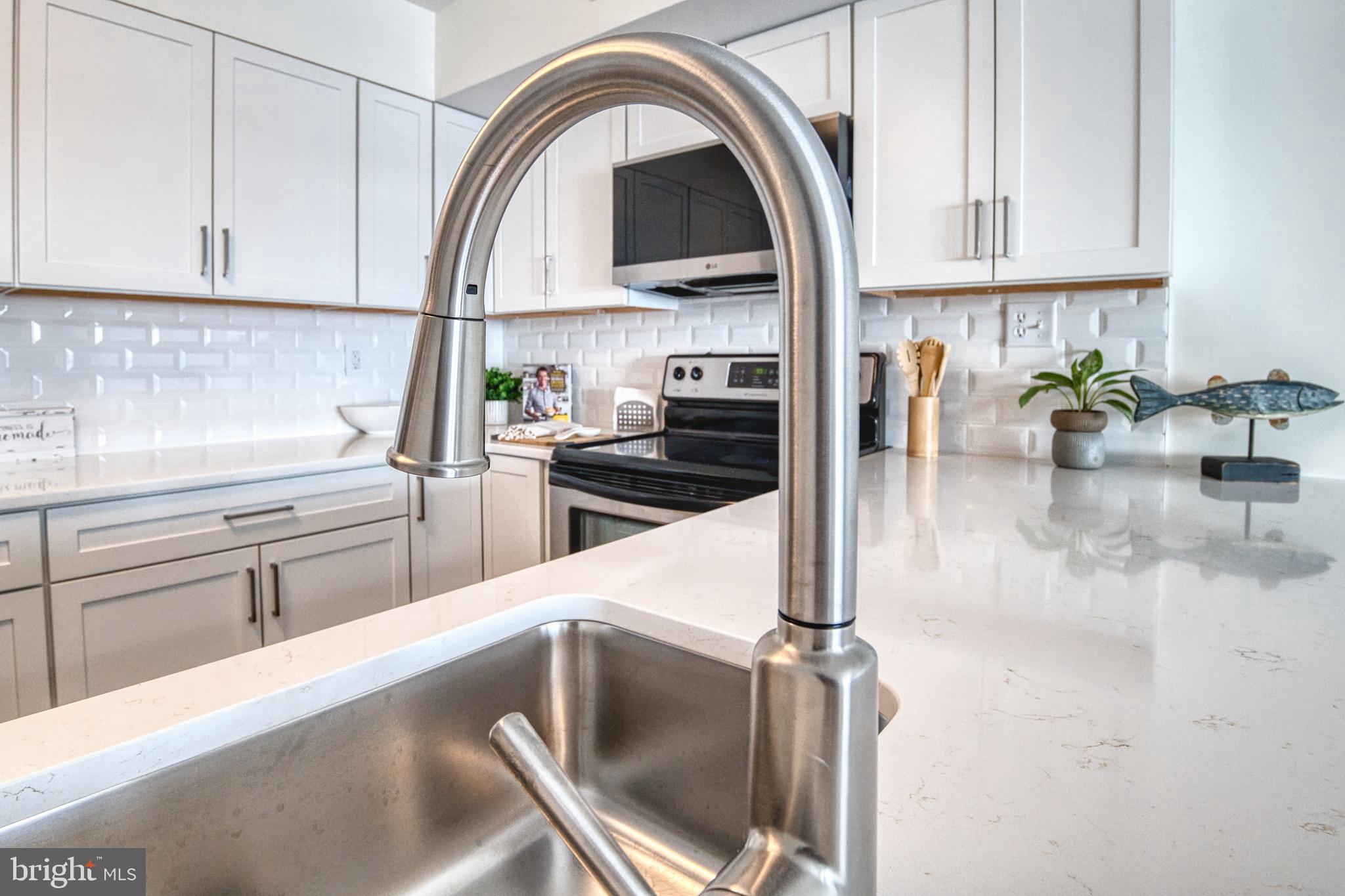 34 Queen Anne Way Chester, MD 21619 - Photo 5 of 52 a kitchen with a sink a stove and cabinets