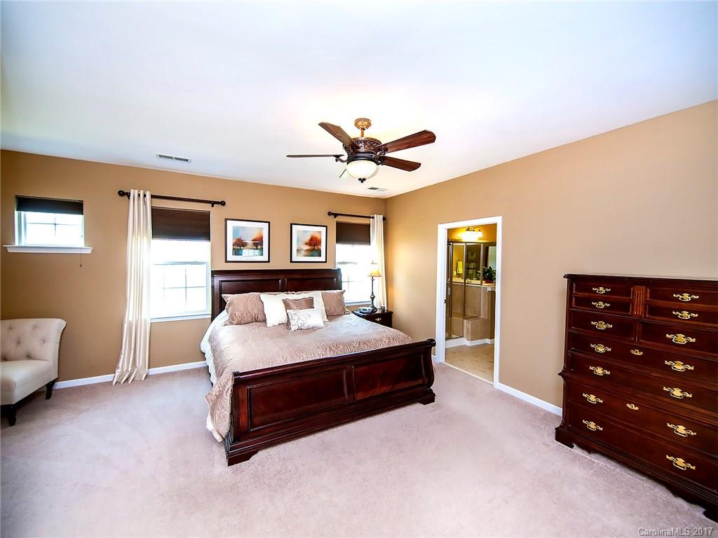 4242 Perth Road Indian Land, SC 29707 - Photo 13 of 24 a spacious bedroom with a bed and a chandelier