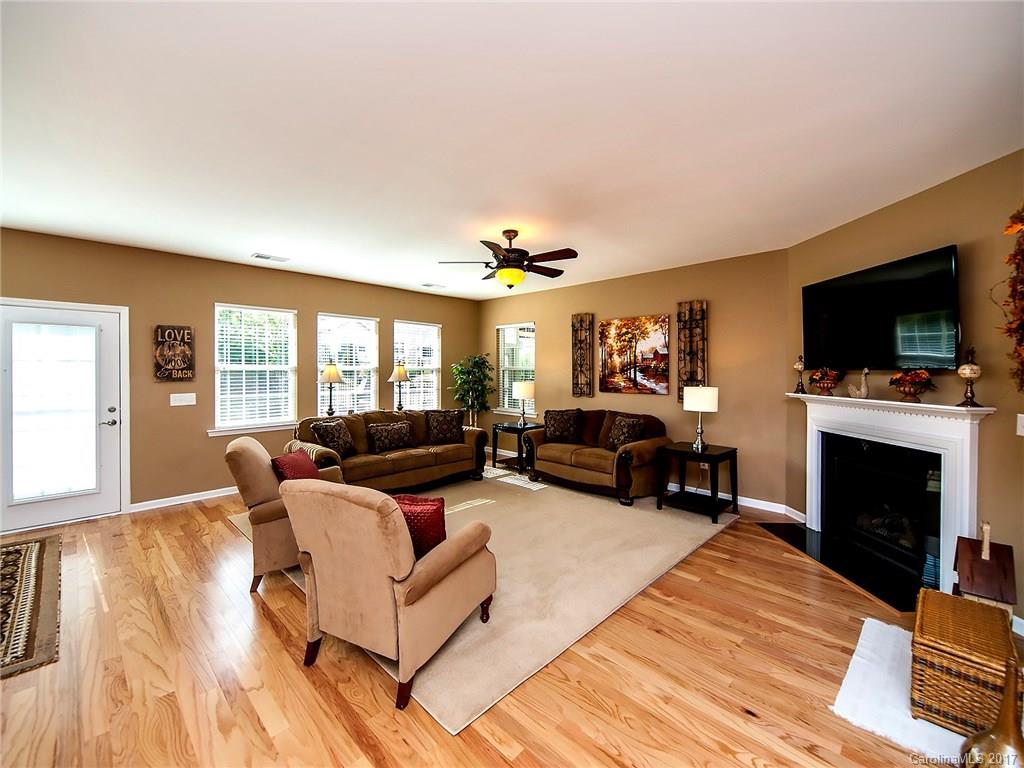 4242 Perth Road Indian Land, SC 29707 - Photo 8 of 24 a living room with furniture a fireplace and a flat screen tv