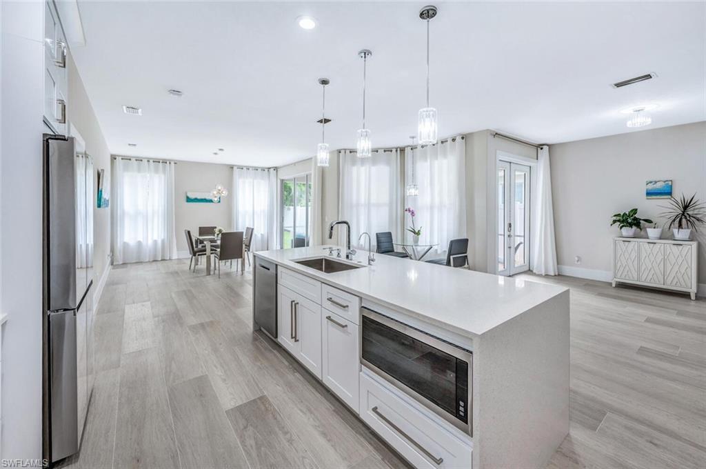 8260 Laurel Lakes Boulevard Naples, FL 34119 - Photo 14 of 41 a large white kitchen with a large window