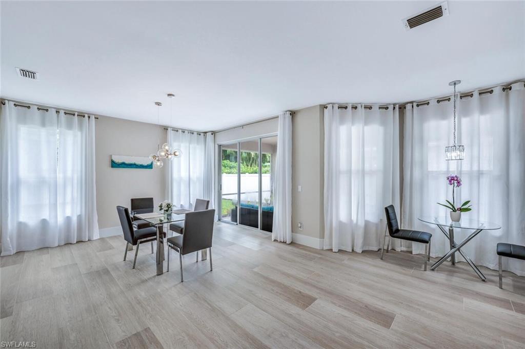 8260 Laurel Lakes Boulevard Naples, FL 34119 - Photo 17 of 41 a view of a dining room with furniture and window