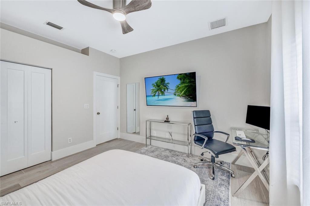 8260 Laurel Lakes Boulevard Naples, FL 34119 - Photo 25 of 41 a bedroom with a workspace