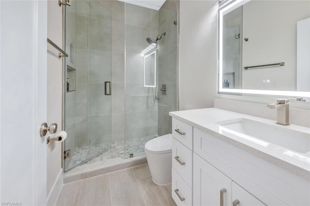 8260 Laurel Lakes Boulevard Naples, FL 34119 - Photo 27 of 41 a bathroom with a sink toilet and shower