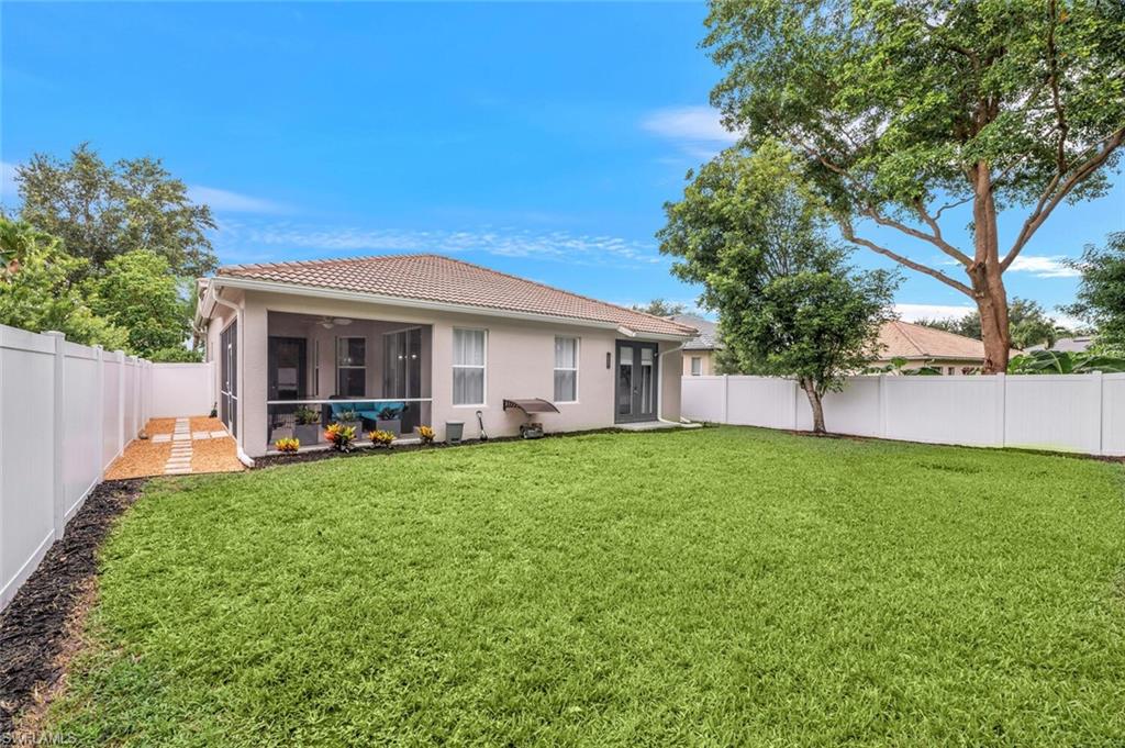 8260 Laurel Lakes Boulevard Naples, FL 34119 - Photo 31 of 41 a view of a house with backyard porch and garden