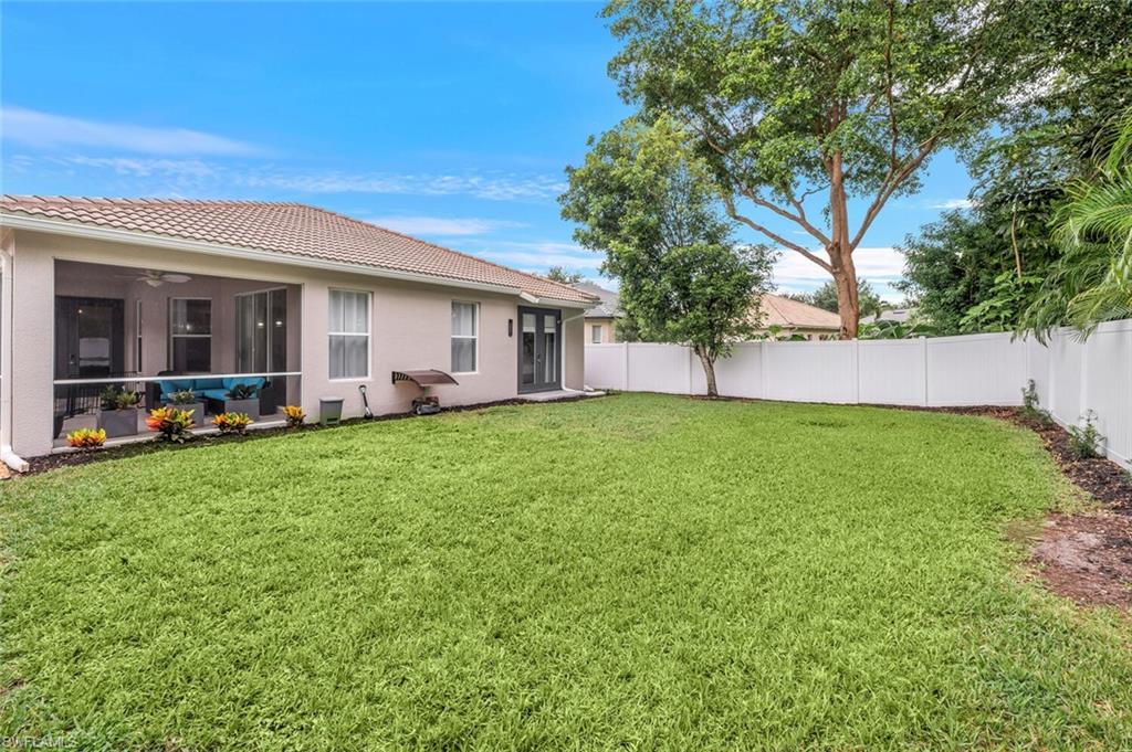 8260 Laurel Lakes Boulevard Naples, FL 34119 - Photo 32 of 41 a view of a house with a back yard