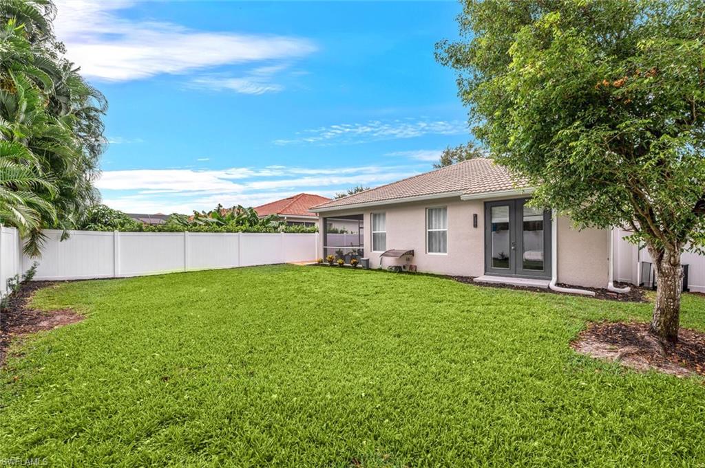 8260 Laurel Lakes Boulevard Naples, FL 34119 - Photo 34 of 41 a view of a house with backyard and a garden