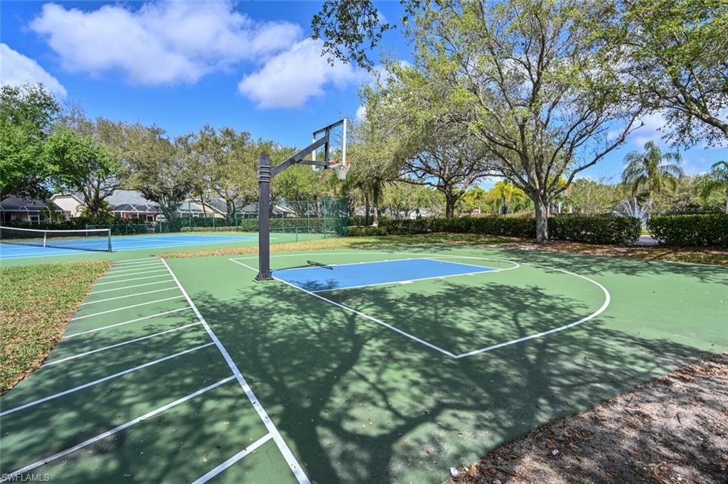 8260 Laurel Lakes Boulevard Naples, FL 34119 - Photo 37 of 41 a view of a tennis ground with large trees