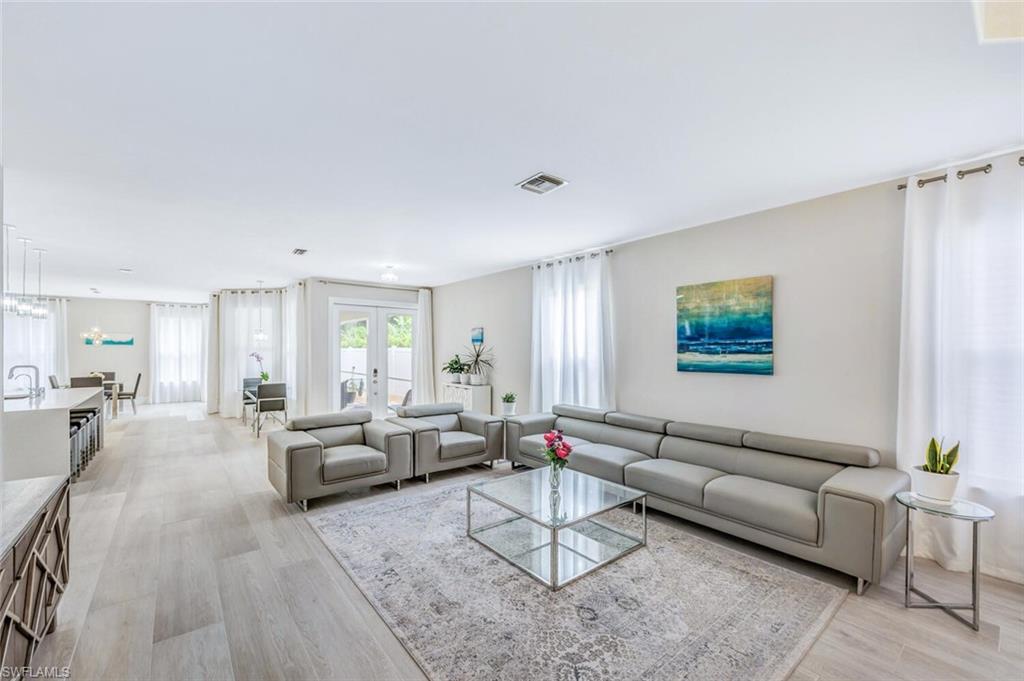 8260 Laurel Lakes Boulevard Naples, FL 34119 - Photo 7 of 41 a living room with furniture wooden floor and window