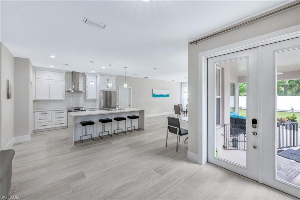 8260 Laurel Lakes Boulevard Naples, FL 34119 - Photo 8 of 41 a view of kitchen with kitchen island and living room