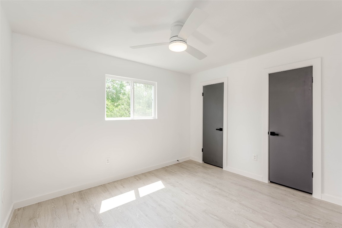 513 Pecan Grove Road, Unit 102 Austin, TX 78704 - Photo 12 of 15 an empty room with windows and closet