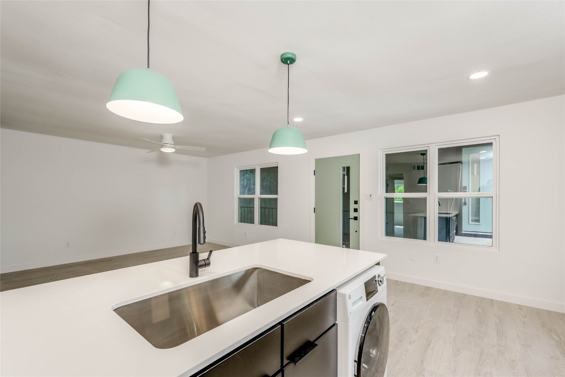 513 Pecan Grove Road, Unit 102 Austin, TX 78704 - Photo 6 of 15 a kitchen with a table and chandelier