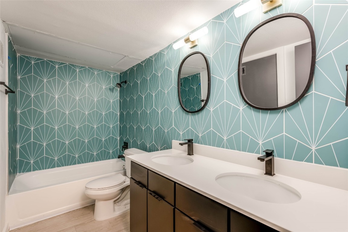 513 Pecan Grove Road, Unit 102 Austin, TX 78704 - Photo 9 of 15 a bathroom with a sink a toilet and a mirror